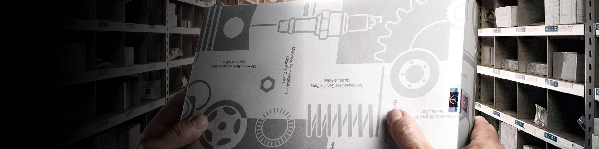 Hands holding Mercedes Partspro part box.