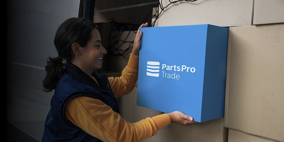 Woman holding blue PartsPro Trade box.