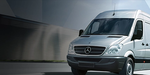 Mercedes van driving on a highway.