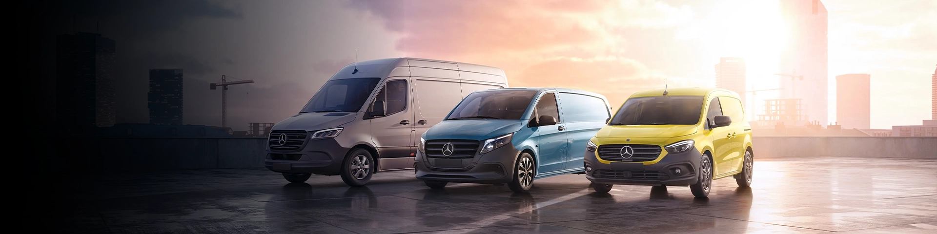 Large, medium and small Mercedes vans in the parking lot.
